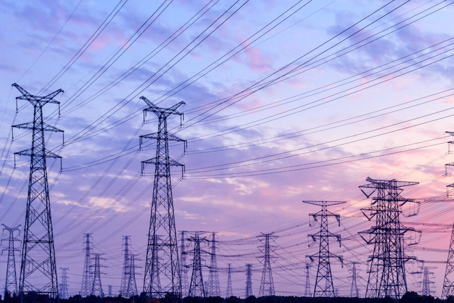 high-voltage power lines at sunset,high voltage electric transmission tower